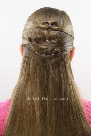 Need a cute Valentine's Day heart hairstyle but don't have much time? Try this quick and easy triple heart pullback hairstyle from BabesInHairland. Love is in the hair with this cute Valentine's Day hairstyle. #hair #valentinesday #hearthair #hearts #loveisinthehair