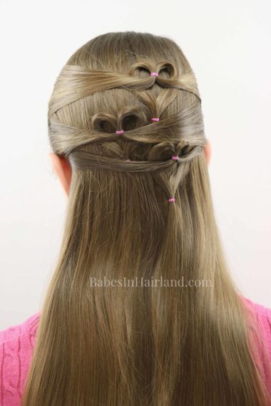 Need a cute Valentine's Day heart hairstyle but don't have much time? Try this quick and easy triple heart pullback hairstyle from BabesInHairland. Love is in the hair with this cute Valentine's Day hairstyle. #hair #valentinesday #hearthair #hearts #loveisinthehair
