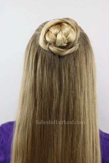 A new spin on a regular bun. Try this quick and easy pulled apart bun and you'll be out the door in no time. Your bun even has a surprise in the middle! BabesInHairland. #bun #hair #hairstyle #braid #easyhairstyle